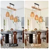 A dining room with a table and chairs, featuring a pendant light fixture. Produktbild-Vorschau