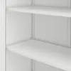 A close-up view of white shelves inside a cabinet. Voir les images du produit