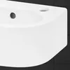 A close-up view of a white ceramic sink with a drain hole and a soap dish holder. Podgląd zdjęcia produktu