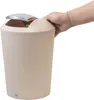 A hand is shown opening the lid of a beige trash can. Produktbild-Vorschau