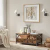 A living room scene featuring a coffee table with decorative items and a framed artwork on the wall. Produktbild-Vorschau