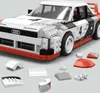 A LEGO model of an Audi Quattro rally car is shown, with some individual LEGO pieces scattered around it. Anteprima dell’immagine prodotto
