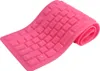 A pink, flexible silicone keyboard is shown on a white background, partially rolled up. Podgląd zdjęcia produktu