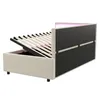 A bed frame with the mattress support raised, revealing storage space underneath. The headboard has integrated LED lighting. Náhled obrázku produktu