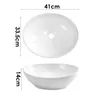 A top-down and side view of a white ceramic oval basin with dimensions indicated. Produktbild-Vorschau