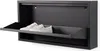A black shoe cabinet with a flap door open, revealing a pair of white sneakers inside. Produktbild-Vorschau