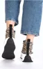 A close-up rear view of a person wearing jeans and leopard print sneakers. Produktbild-Vorschau