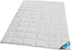 A white quilted comforter laid out on a white background. Produktbild-Vorschau