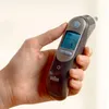 A hand holding a Braun ear thermometer. Produktbild-Vorschau