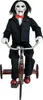 A doll of Billy the Puppet from the Saw movies is riding a red tricycle. Produktbild-Vorschau