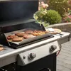 A barbecue grill with steaks, sausages, and skewers cooking on a griddle. Podgląd zdjęcia produktu
