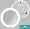 A white LED makeup mirror with a suction cup attachment and a battery compartment is shown against a light gray background. The mirror has a bright ring light around its edge. Produktbild-Vorschau