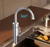 A modern kitchen sink area with a silver faucet, a pot in the background, and fruit in the sink. Podgląd zdjęcia produktu