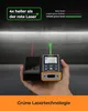 A hand holding two laser distance measurers, one with a red laser and one with a green laser, against a concrete wall background. Anteprima dell’immagine prodotto