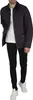 A man wearing a navy quilted jacket over a white t-shirt and black pants, standing against a white background. Produktbild-Vorschau
