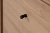 A close-up view of a black drawer pull on a wooden surface. Produktbild-Vorschau