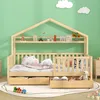 A child's bed with a house-shaped frame and shelves, set against a green wall with cloud decorations. Voir les images du produit