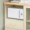 A white microwave is placed on a shelf within a beige cabinet, with a wooden countertop above. Voir les images du produit