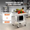 A stainless steel kitchen cart with a microwave and food items on top, set in a commercial kitchen environment. Produktbild-Vorschau