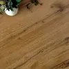 A close-up view of a wooden table with a vase of flowers on it. Podgląd zdjęcia produktu