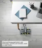 A vacuum cleaner head under a desk with a laptop and notebook on the desk. Produktbild-Vorschau