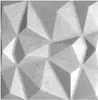 A close-up, textured view of a gray geometric wall panel.