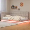 A modern bedroom with a beige upholstered bed featuring LED lighting. Produktbild-Vorschau