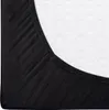 A close-up view of a black fitted sheet on a white mattress. Náhled obrázku produktu