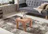 A living room scene with a sofa, coffee table, and rug. Anteprima dell’immagine prodotto