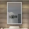 A bathroom mirror with LED lighting is mounted above a sink, reflecting a wall with artwork and a door. Anteprima dell’immagine prodotto