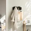 A coat and a bag hang on a wall-mounted hook rack in a hallway. Anteprima dell’immagine prodotto