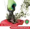 A hand wearing a green glove is holding a garden shredder attachment over a red bin filled with branches and leaves. Produktbild-Vorschau