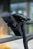 A close-up shot of a black bicycle lock mounted under a bicycle seat. Voir les images du produit
