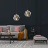 A modern living room with a sofa, coffee table, and pendant lights. Podgląd zdjęcia produktu