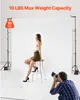 A photographer takes a picture of a model sitting on a stool in a studio with a white backdrop. Náhľad obrázku produktu