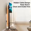 A TV stand with a TV mounted on it, placed in a room with blinds and a wall outlet. Anteprima dell’immagine prodotto
