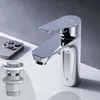 A chrome faucet and pop-up drain assembly on a white sink surface with a gray background. Produktbild-Vorschau