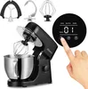 A black ZEEGMA kitchen mixer with a stainless steel bowl and various attachments is shown, with a hand interacting with its digital display. Náhled obrázku produktu