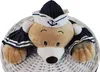 A plush teddy bear dressed as a sailor is peeking out of a white wicker laundry basket. Anteprima dell’immagine prodotto