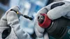 A close-up shot of hands wearing work gloves holding a Bosch screwdriver bit and a Bosch impact driver. Voir les images du produit