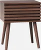 A wooden nightstand with a slatted front and tapered legs, presented against a white background. Produktbild-Vorschau