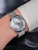 A close-up shot of a woman's wrist wearing a silver Guess watch. Náhled obrázku produktu