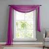 A sheer purple scarf draped over a window, with a chair visible on the right. Produktbild-Vorschau