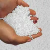 Hands holding a pile of white styrofoam beads. Produktbild-Vorschau