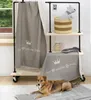 A dog is lying on a blanket in front of a shelf unit displaying pet accessories. Produktbild-Vorschau