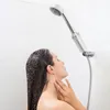 A woman is showering with a shower filter attached to the shower head. Náhľad obrázku produktu