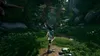 A character runs through a lush forest towards a wooden archway. Produktbild-Vorschau