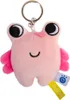 A close-up studio shot of a pink plush keychain shaped like a frog. Voir les images du produit