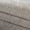 A close-up view of a folded beige and white textured rug. Produktbild-Vorschau