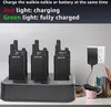 A multi-way charger with several walkie-talkies plugged in, with a power adapter plugged into a wall socket. Náhled obrázku produktu